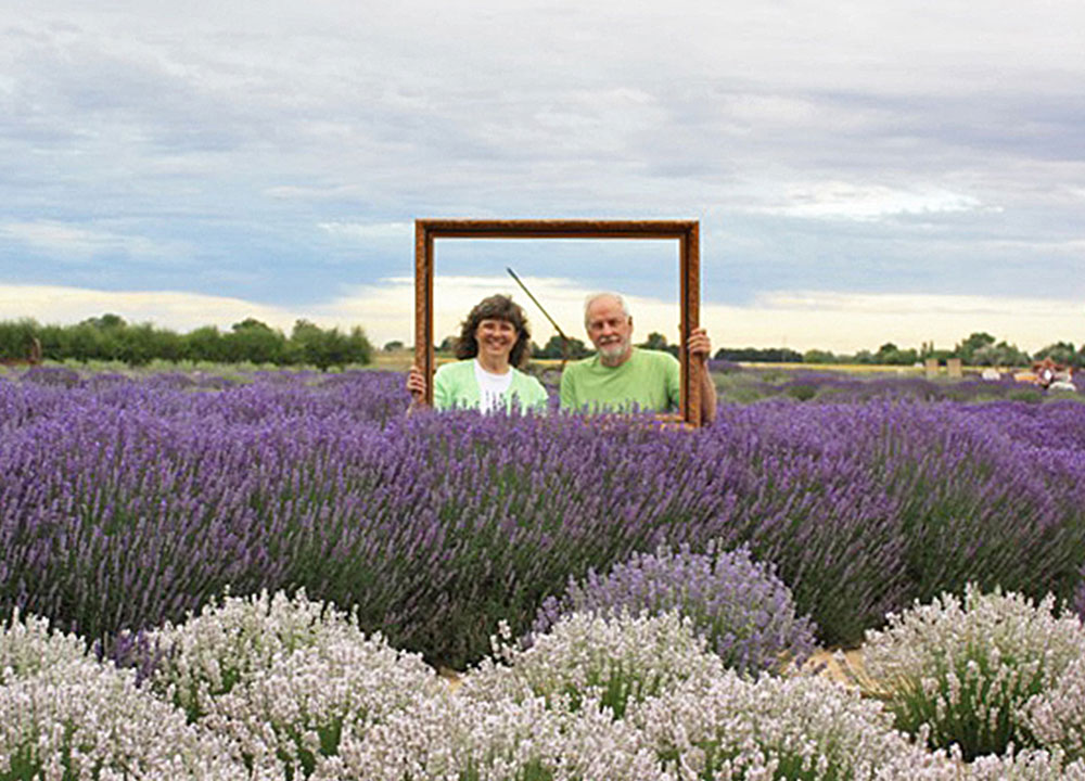Lavender Acres owners Mike and Donna in field of purple and white lavender